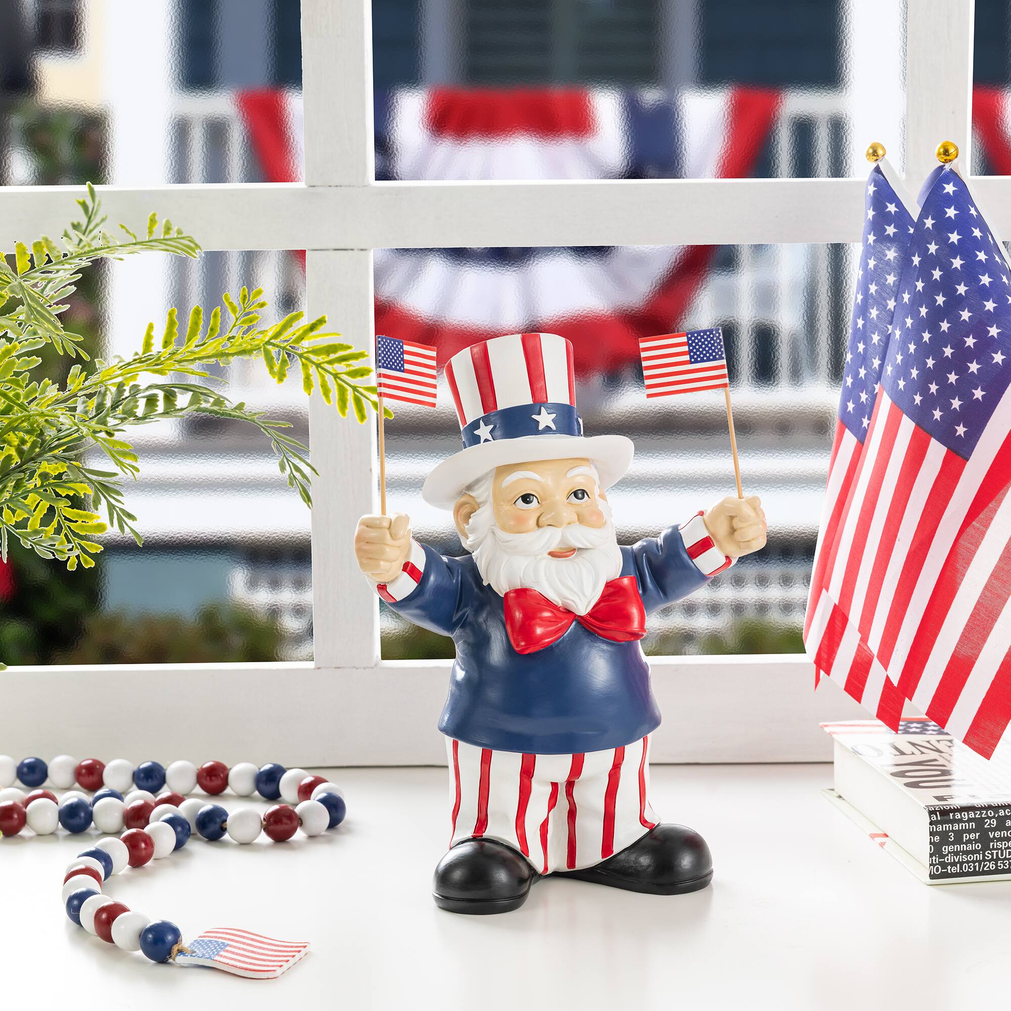 Glitzhome® 9" Patriotic Americana Polyresin Santa Holding Flags Table Decor
